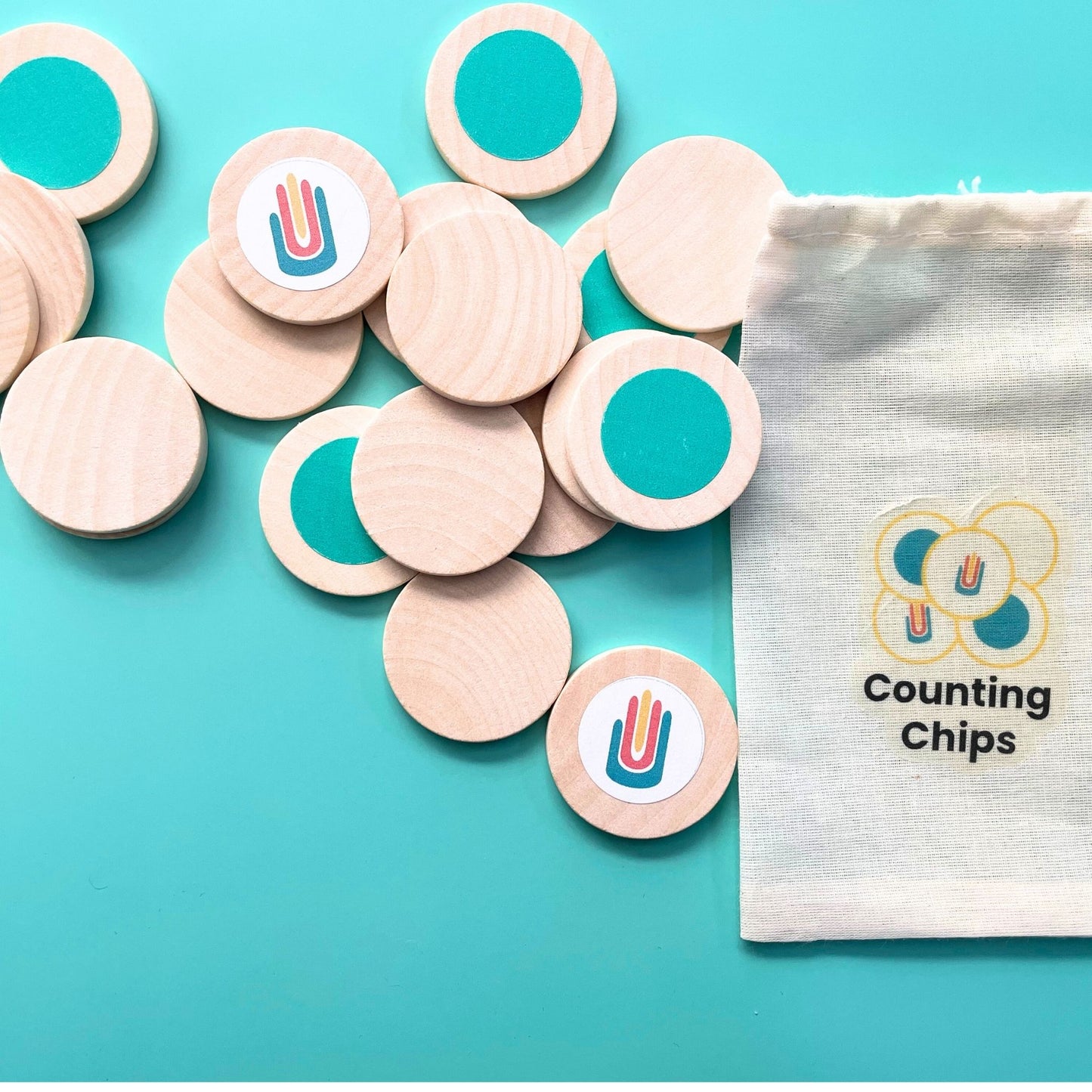 Wooden counting chips with teal dots and Math in Reach logo, shown with labeled storage pouch.