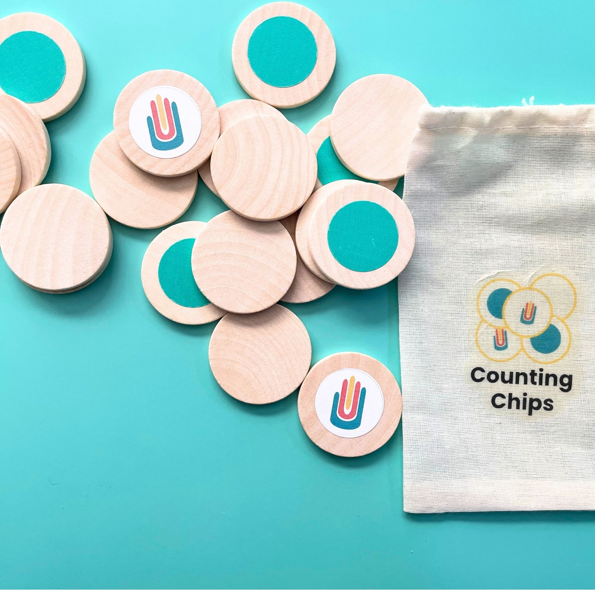 Wooden counting chips with teal dots and Math in Reach logo, shown with labeled storage pouch.