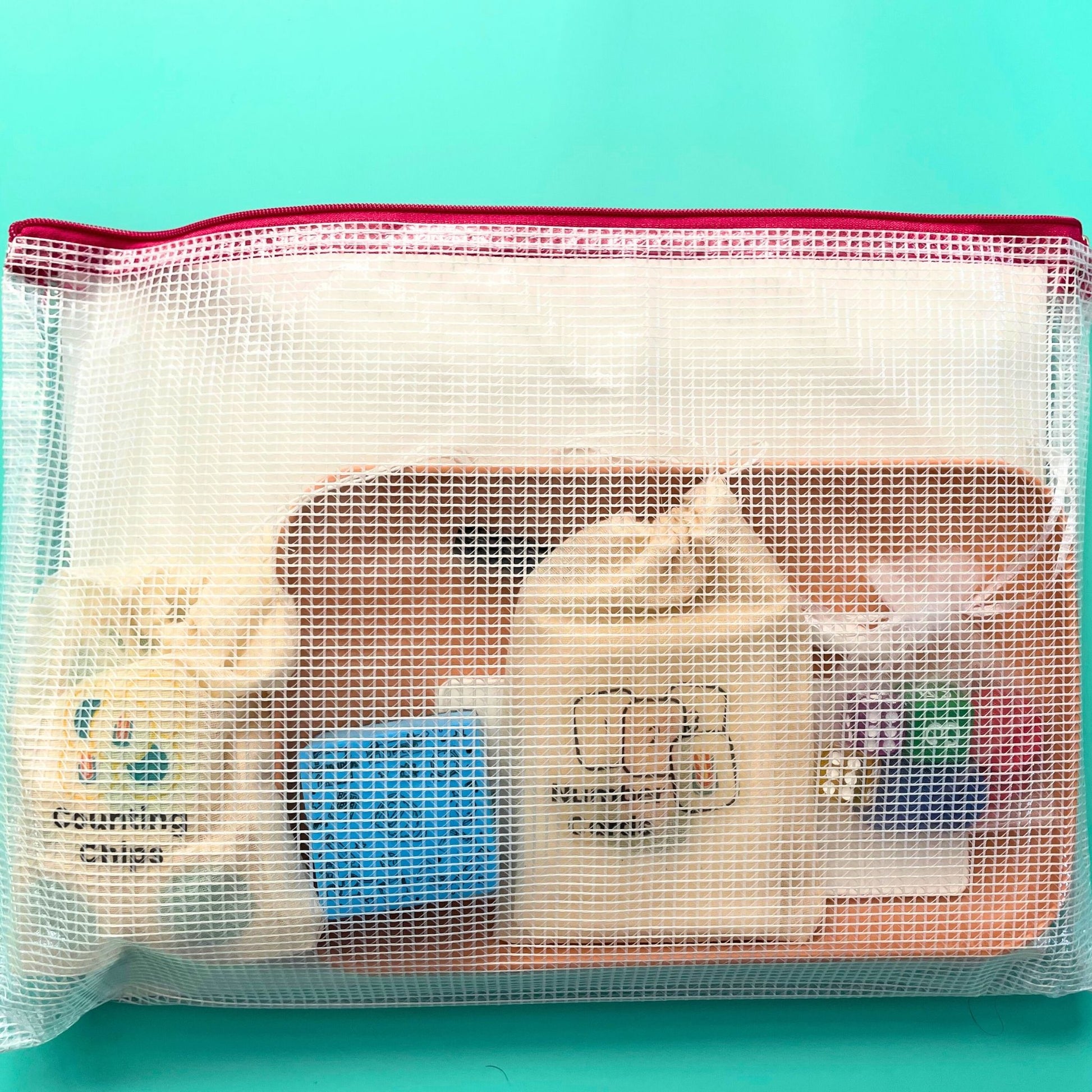 Math in Reach Starter Kit packed neatly in mesh storage pouch with counting chips, number cards, dice, and tray visible inside.