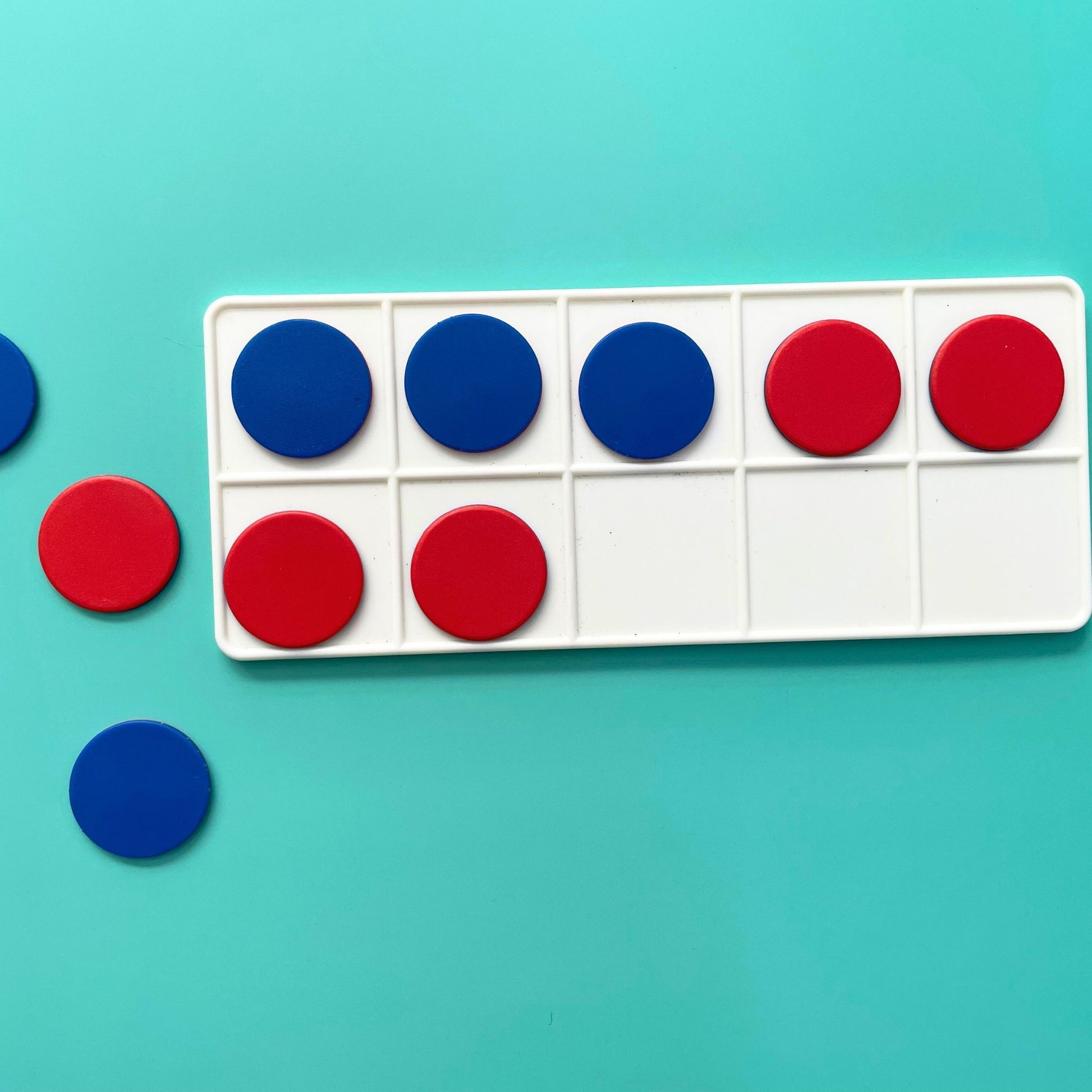 Red and blue counters placed in a ten-frame math tool to support hands-on counting practice.